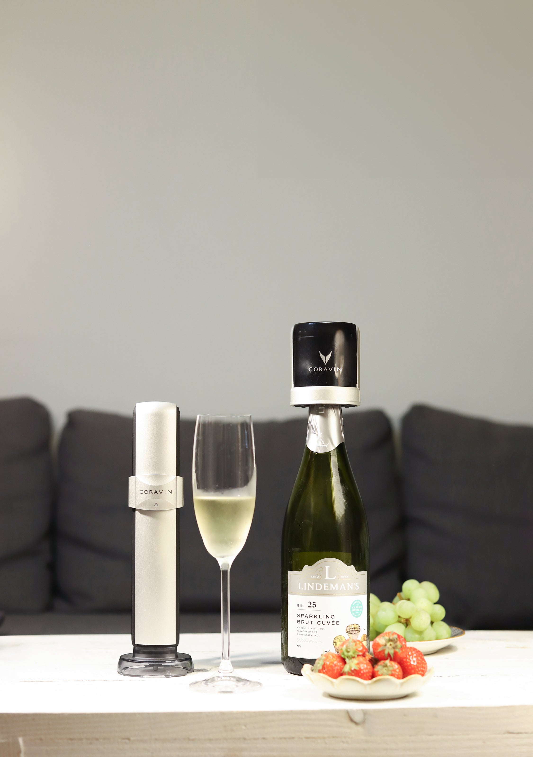 Couple sitting outside enjoying a bottle of Champagne with the Coravin Sparkling device